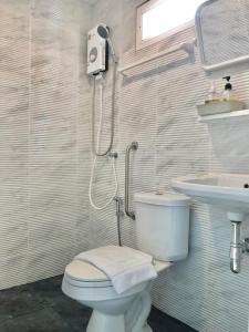 a bathroom with a toilet and a sink at กบอุทัย รีสอร์ท in Ban Don Khwang