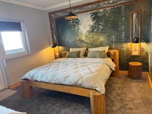 a bedroom with a bed with a painting on the wall at GB Cazare in Volovăţ