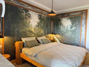a bedroom with a bed with a painting on the wall at GB Cazare in Volovăţ