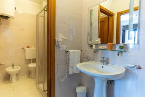 a bathroom with a sink and a toilet at Rina Sea Apartments in Alghero