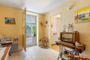 a living room with a tv on a table at Chambres Escale Pontilabienne in Pont-lʼAbbé-dʼArnoult +38 photos
