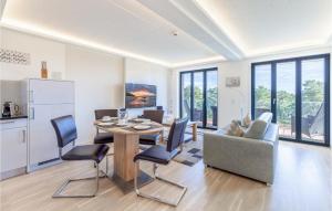 a kitchen and living room with a table and chairs at Prince in Binz