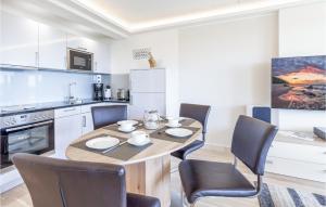 a kitchen with a dining room table and chairs at Prince in Binz +27 photos