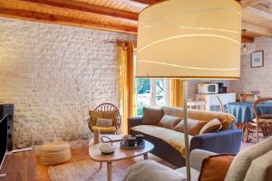 a living room with a couch and a table at Gîte Le Gué De Champagné in Torxé