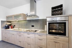 a kitchen with wooden cabinets and a stove top oven at Feriennest Balve in Balve