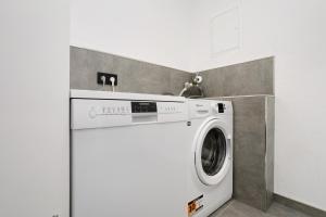 a washer and dryer in a kitchen with a wall at Feriennest Balve in Balve