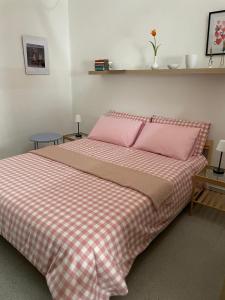 a bedroom with a bed with pink pillows at Via Spani 13 in San Pietro Vernotico