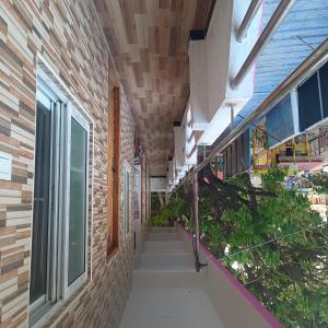 a hallway of a building with stairs and windows at Durga Residency in Alāndurai