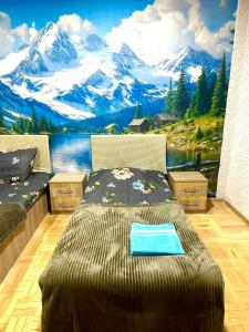 a bedroom with a large bed with a mountain mural at Budget Home in Kutaisi