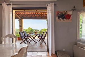 a living room with a patio with a table and chairs at Chambre D'hôtes Les 5 Calanques in Ensuès-la-Redonne