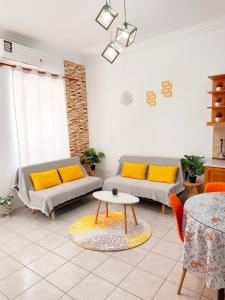 a living room with two couches and a table at Twins home in Ierapetra