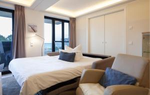 a bedroom with a bed and a couch and windows at Prince in Binz