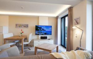 a living room with a table and a dining room at Prince in Binz