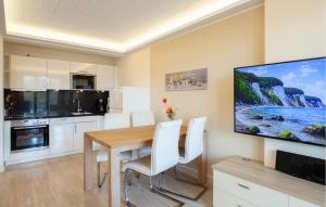 a kitchen with a wooden table and a tv on the wall at Prince in Binz +29 photos
