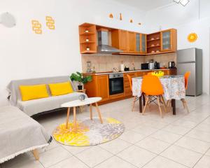 a kitchen and living room with a couch and a table at Twins home in Ierapetra