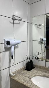 a bathroom with a blow dryer and a sink at Flat Gran Solare Lençóis Barreirinhas in Barreirinhas +36 photos