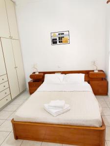 a bedroom with a bed with two white towels on it at Twins home in Ierapetra +6 photos