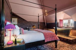 a bedroom with a large bed and a bathroom at Manoir de Lébioles in Spa +37 photos