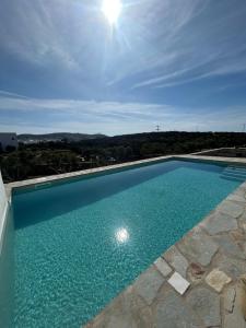 a swimming pool with blue water on a building at Vios Boutique Houses in Antiparos