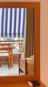 a mirror reflection of a bed on a balcony at Spilea Apartments in Himare
