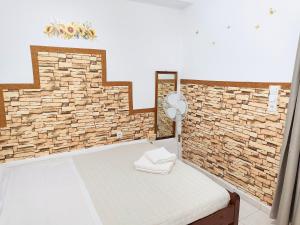 a room with a brick wall and a bed at Twins home in Ierapetra