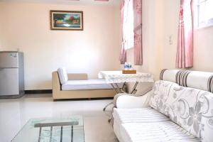 a living room with a couch and a table at Xuan Luom Guesthouse in Phan Thiet