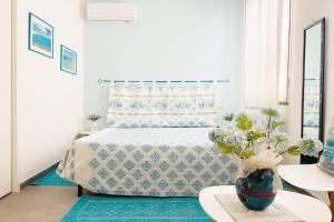 a bedroom with a bed and a vase on a table at La Pavoncella in Oristano