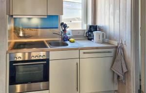 a kitchen with a sink and a stove at Friedrichskoog-Strandpark 1 in Friedrichskoog