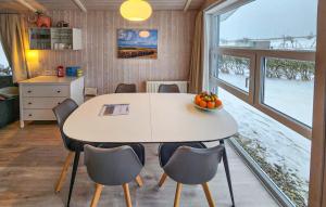 a dining room with a table and chairs and a window at Friedrichskoog-Strandpark 1 in Friedrichskoog