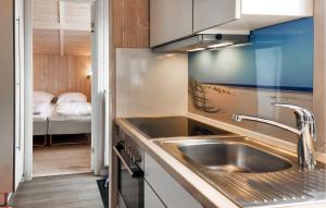 a kitchen with a sink and a bed in a room at Friedrichskoog-Strandpark 1 in Friedrichskoog
