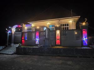 a house with colorful lights on the doors at night at NIGO EXECUTIVE LODGE Mahenge in Mahenge +10 photos