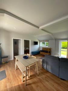 a living room with a table and a couch at St Ronans Cottages in Duffstown
