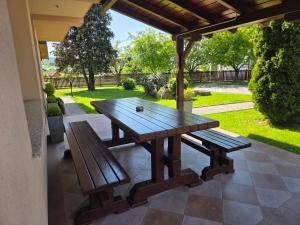 a picnic table and two benches on a patio at House Bogović in Karlovac