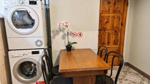 a laundry room with a table and a washing machine at For rest Hostel in Lublin