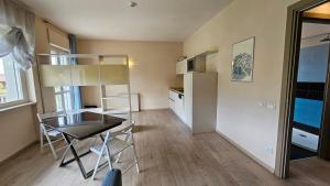 a small room with a table and a refrigerator at Hotel Residence Juvarra Centro Benessere in Biella +18 photos