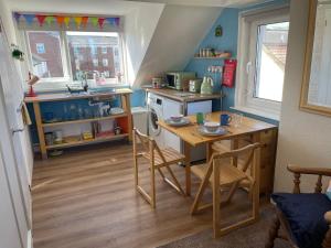 a small kitchen with a table and a stove at Hope Corner in Filey