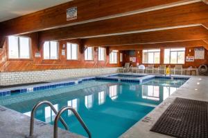 a swimming pool with blue water in a building at Blue Heron Motel in Nags Head
