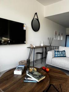 a living room with a coffee table and a tv at KOHILI Seaside Residence in Polis Chrysochous
