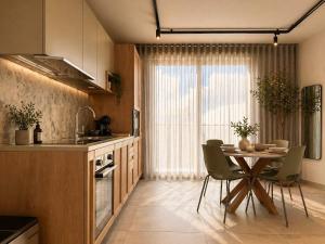 a kitchen with a table with chairs and a dining room at Exclusive Retreat off the Sea Front Promenade in Il-Gżira