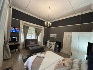 una camera da letto con un letto, un divano e una scrivania di Bright Diamond Inn a Kimberley