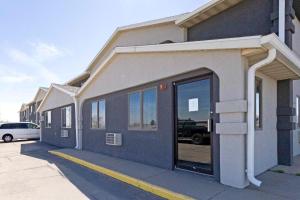 a building with a door open on a street at Mid Rest Inn Lexington NE I-80 in Lexington