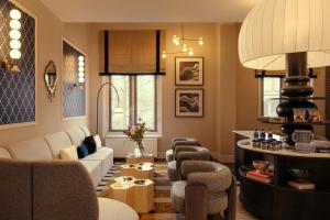 a living room with a couch and chairs at The Manor Amsterdam in Amsterdam