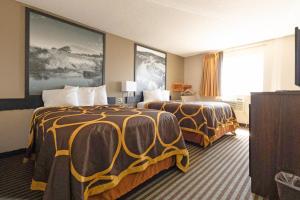 a hotel room with two beds and a window at Mid Rest Inn Lexington NE I-80 in Lexington