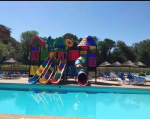 a playground in a pool with a slide at Camping paradis in Clohars-Carnoët +5 photos