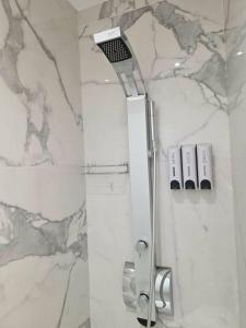 a shower in a bathroom with a marble wall at Dream Home Veria in Veria +21 photos