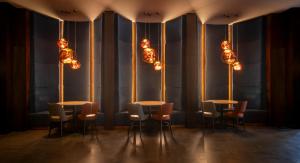 a row of tables and chairs in a room with lights at Clayton Hotel, Leeds in Leeds