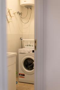 a laundry room with a washing machine and a sink at Maison Gioia di Casa Camilla Journey in Capilungo