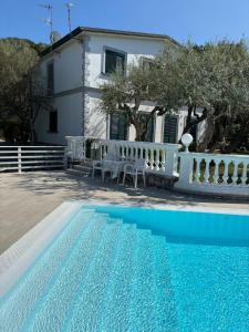 a villa with a swimming pool in front of a house at Tenuta Camporosso in Massa Lubrense