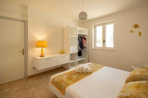 a white bedroom with a bed and a window at Maison Gioia di Casa Camilla Journey in Capilungo +45 photos