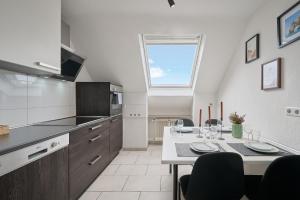 a kitchen with a table and a dining room at SANO - Hagen - Hegel in Hagen